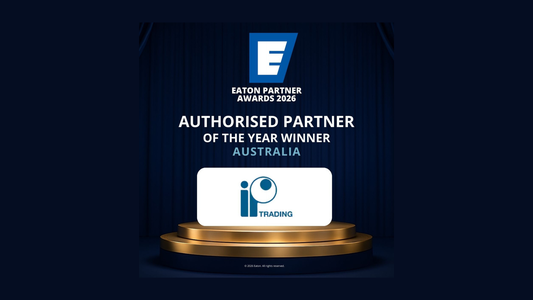 White rectangular plaque with blue io trading logo on golden pedestal awarded ip trading partner of the year 2026 australia