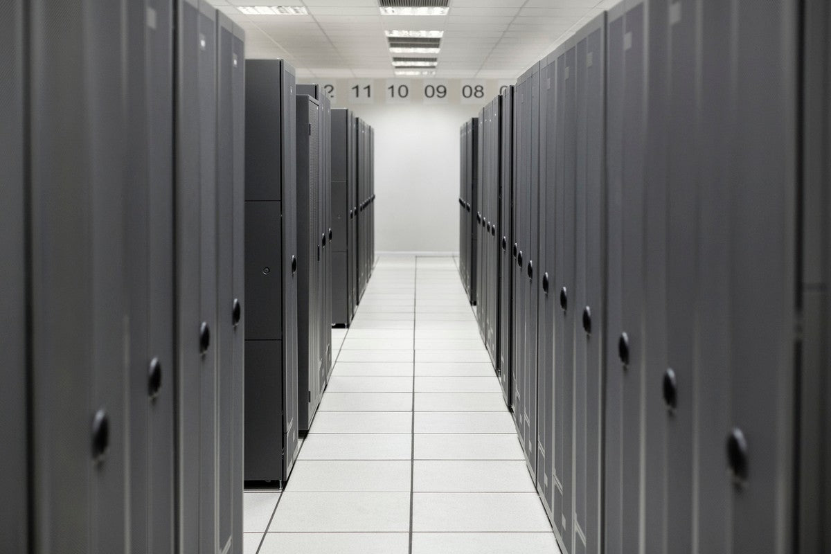 Rows of sleek dark gray server racks in a white corridor illustrating setup for hpe p82106-b21 proliant dl385 gen11 gpu power cable
