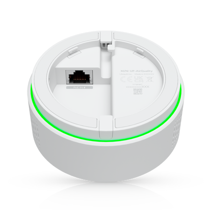 Ubiquiti up-airquality white circular wireless router with glowing green led ring for vape detection and air quality sensing
